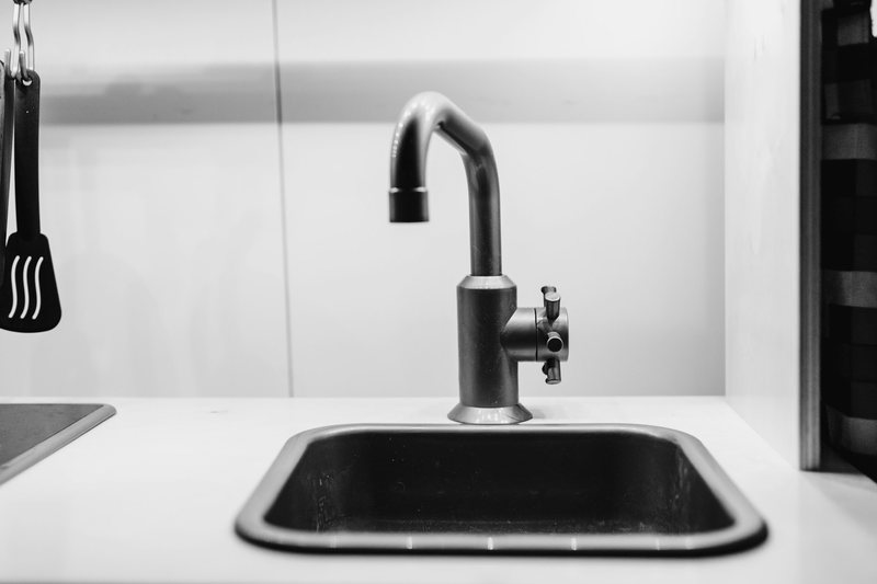 Matte black mixer tap on a kitchen sink